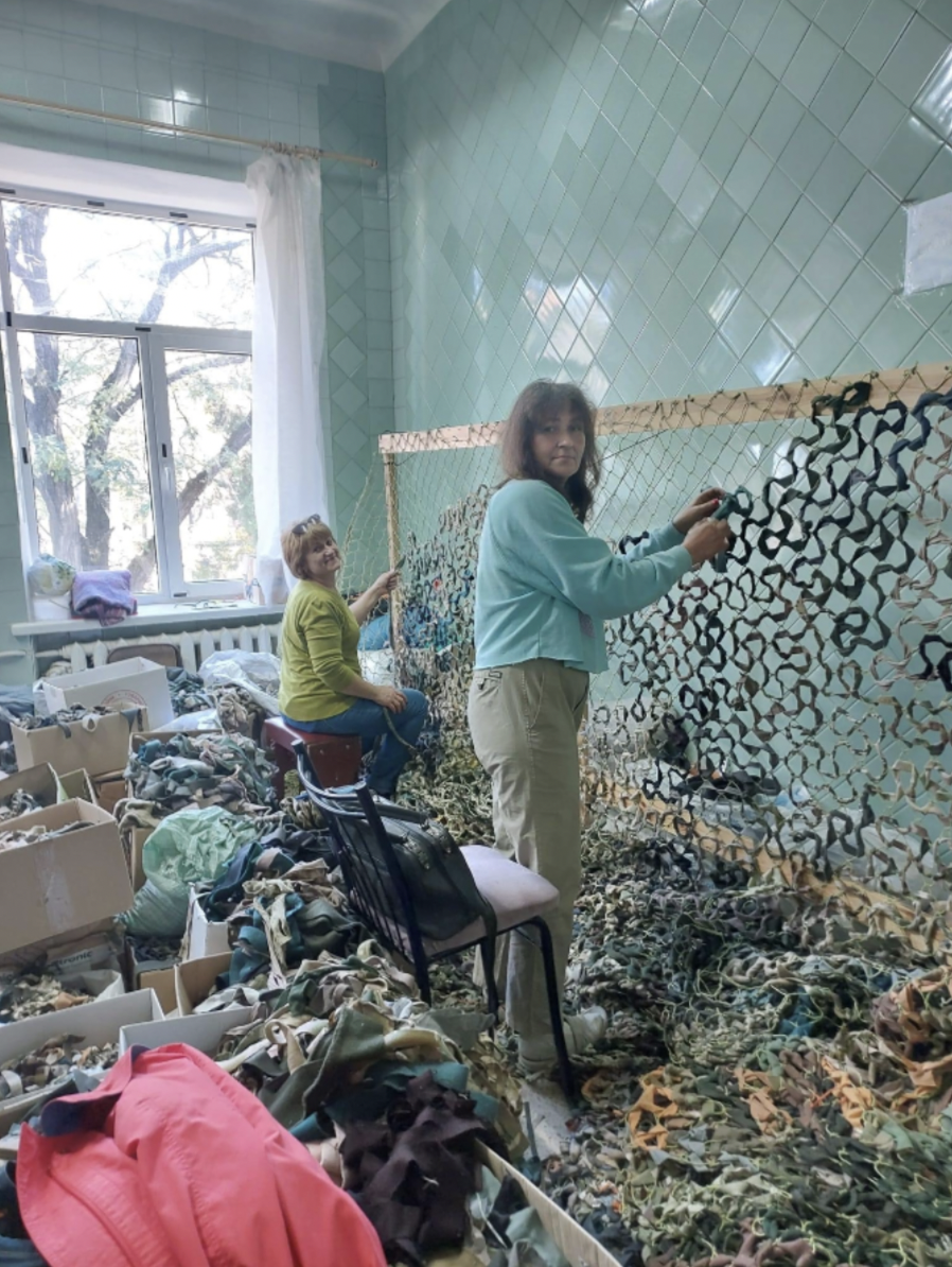 Two Maskuty volunteers making camouflage nets for the Ukrainian military. Photo courtesy of Maryna Nading.